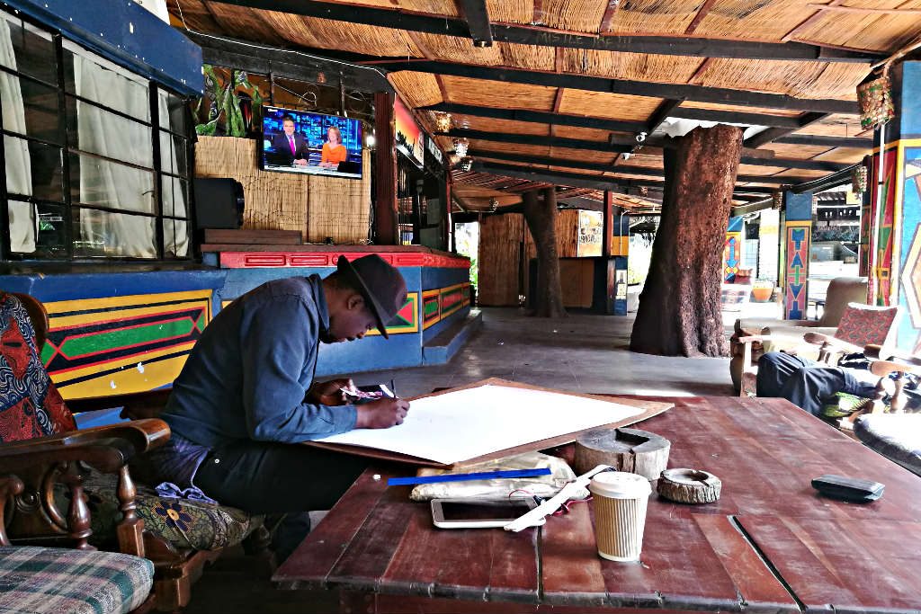 Artist painting at Victoria Falls backpackers