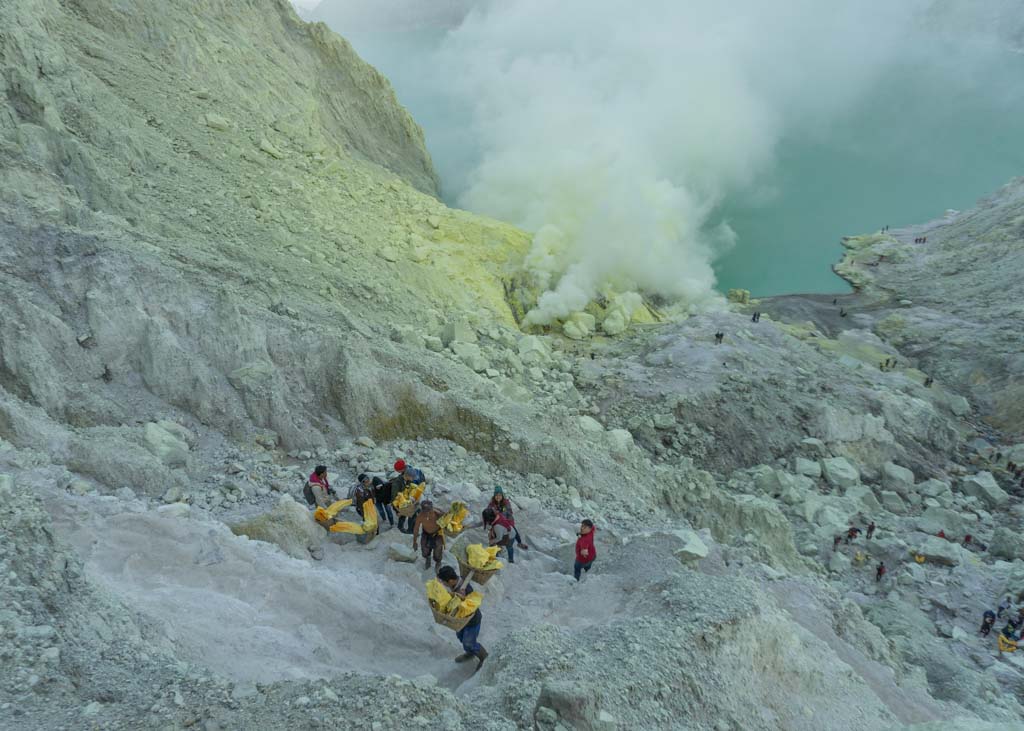 Workers walking out from Mount Ijen in Indonesia