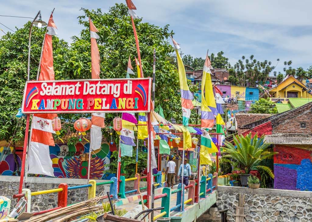 Rainbow village with bright colored flags and signs