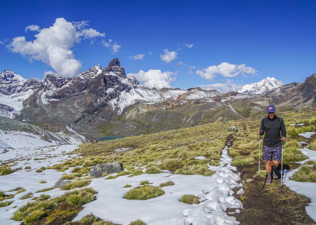 A man walking along a snowy trail to Austria Peak in Bolivia
