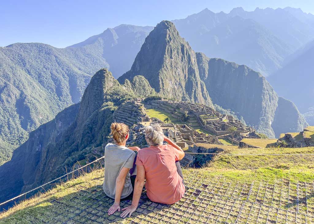 a mother and daughter sitting at Machu Picchu after finishing the 5 day Salkantay trek