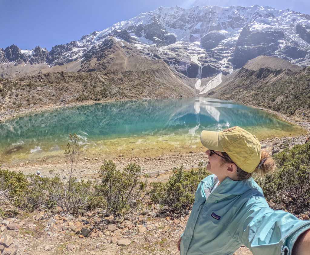 A girl taking a selfie at Humantay Lake on day 1 of the Salkantay trek