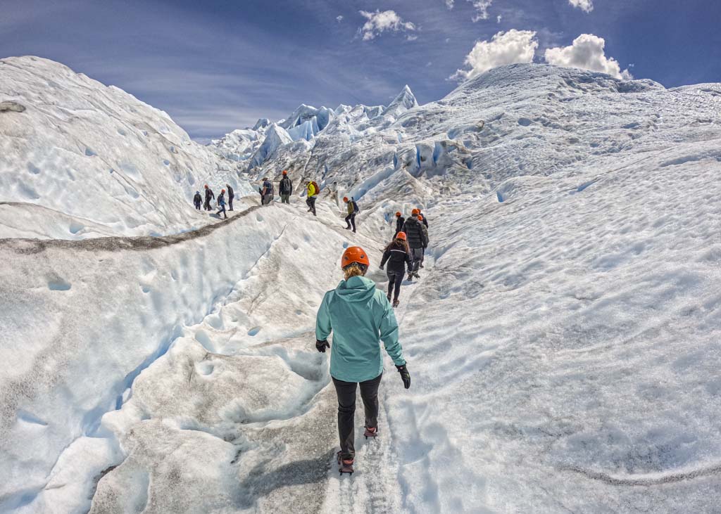 A group of people walking in a line on Perito Moreno Glacier in El Calafate