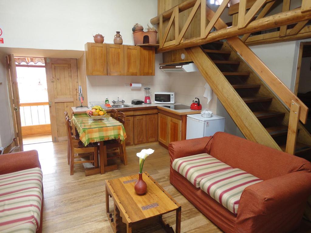 A lounge and kitchen area of a place to stay in Cusco