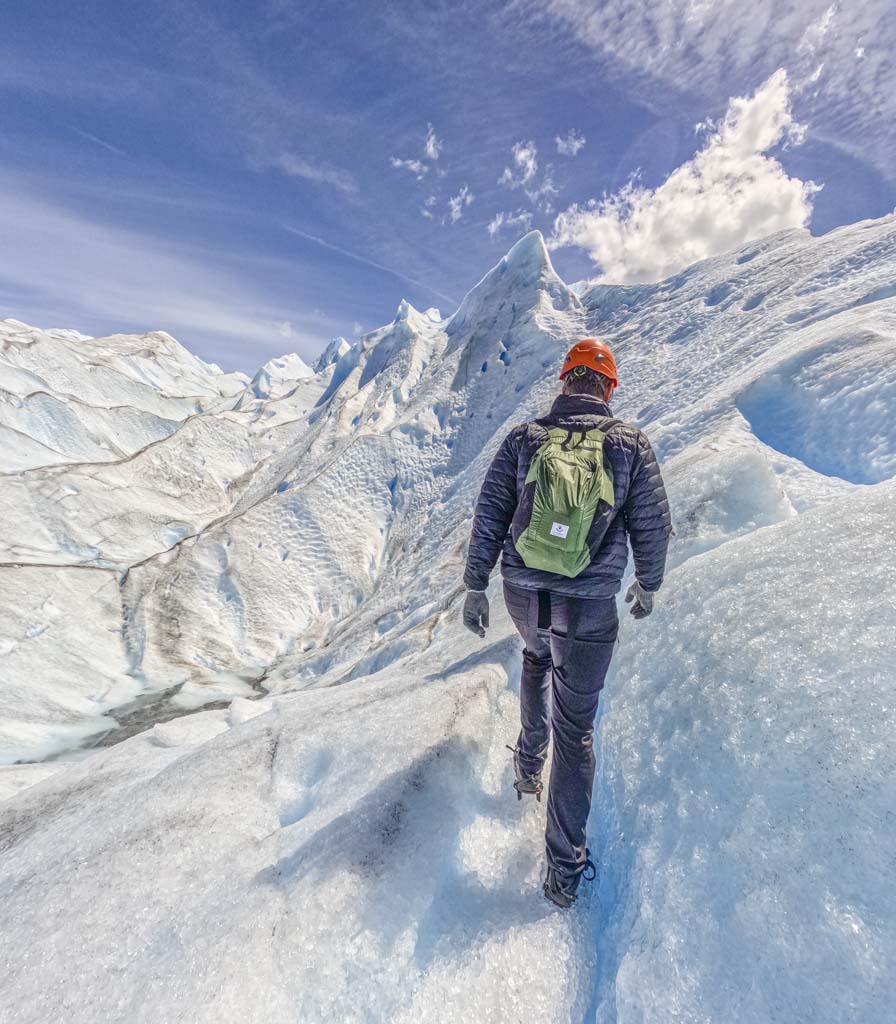 A man walking on a glacier in Patagonia
