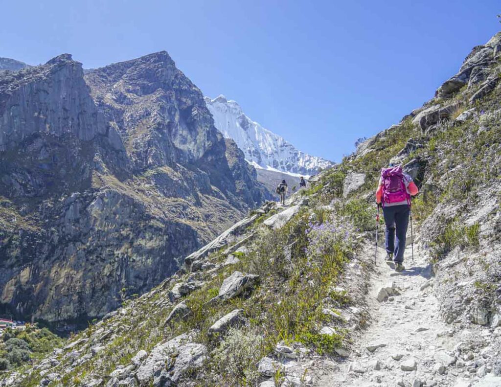 A woman hiking a mountain to get to the Laguna Paron viewpoint in Huaraz