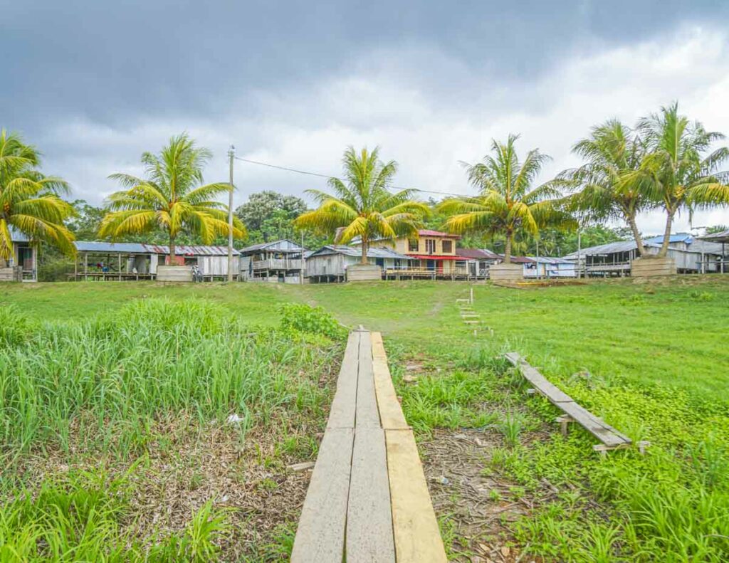 A wooden walkway leading to a village in the Amazon in Peru