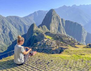 carryn sitting at a viewpoint overlooking Machu Picchu